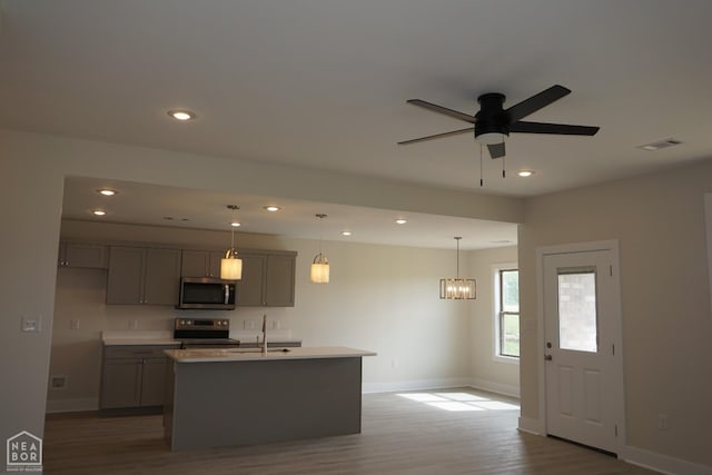 kitchen with visible vents, baseboards, dark wood-style floors, and stainless steel appliances