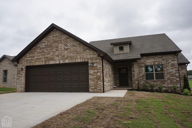 1814 N Oak, Brookland, AR 72417 - view of front of home with driveway, roof with shingles, brick siding, a front lawn, and an attached garage