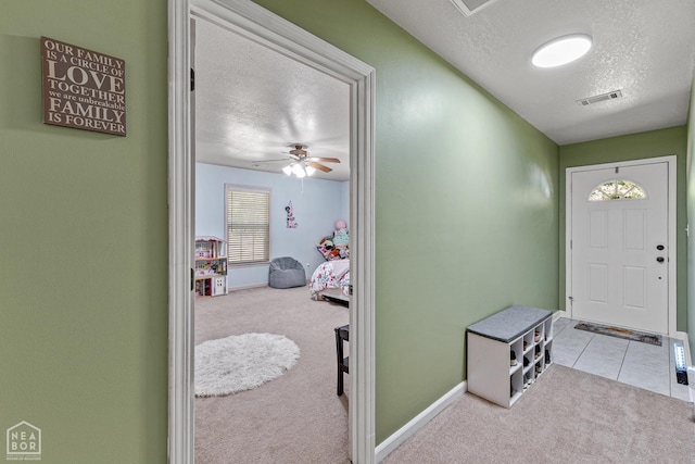 616 Greene 326 Rd, Jonesboro, AR 72401 - tiled foyer entrance with ceiling fan, a textured ceiling, baseboards, and carpet floors