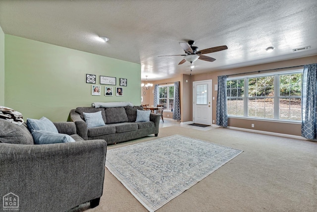 616 Greene 326 Rd, Jonesboro, AR 72401 - living room featuring light carpet, ceiling fan with notable chandelier, visible vents, and a textured ceiling