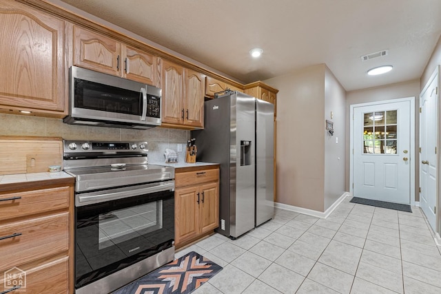 616 Greene 326 Rd, Jonesboro, AR 72401 - kitchen with tile countertops, tasteful backsplash, visible vents, light tile patterned flooring, and stainless steel appliances