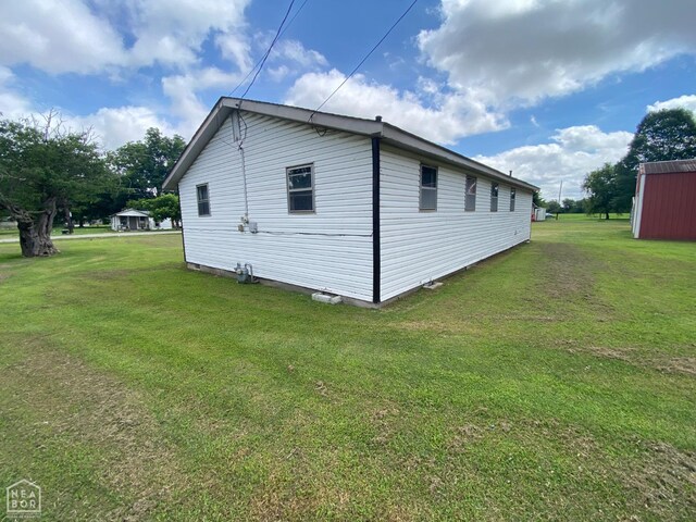 118 Seaton St, Trumann, AR 72472 - kitchen featuring black range with gas cooktop, under cabinet range hood, dark wood-type flooring, washing machine and dryer, and dark countertops