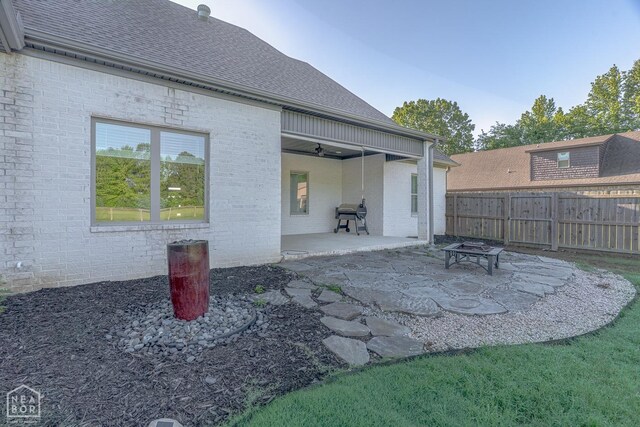 4049 Hwy 351, Jonesboro, AR 72405 - rear view of property with fence, a patio area, brick siding, an outdoor fire pit, and a shingled roof