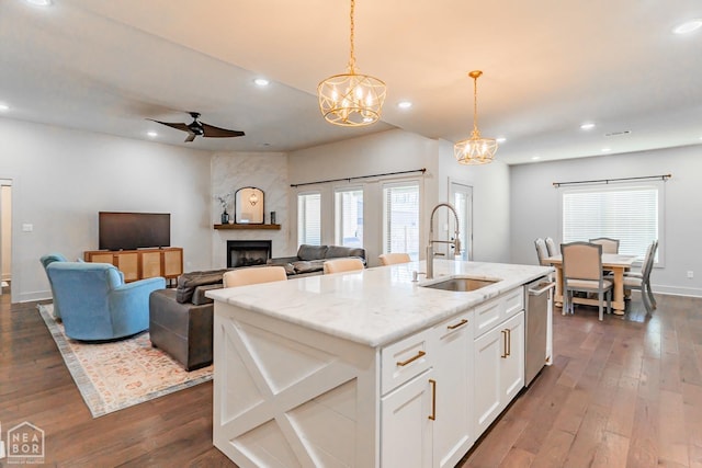 4049 Hwy 351, Jonesboro, AR 72405 - kitchen featuring ceiling fan with notable chandelier, a sink, a fireplace, dark wood-type flooring, and dishwasher