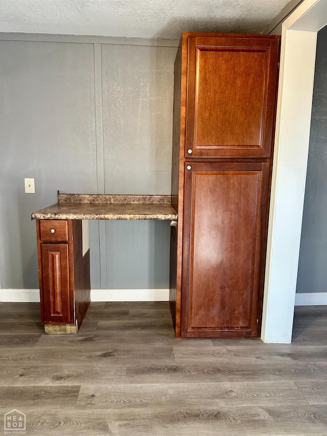513 Lewis Ave, Trumann, AR 72472 - bar featuring a textured ceiling, wood finished floors, and baseboards