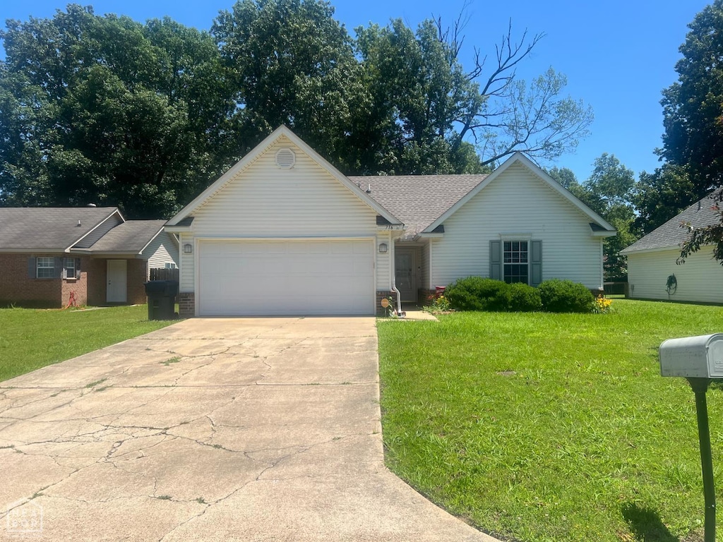 716 Crescent Cv, Jonesboro, AR 72401 - view of front of house featuring a garage, concrete driveway, and a front lawn