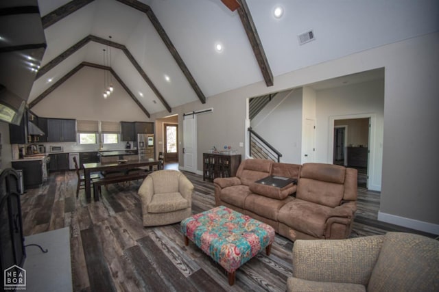 living area with dark wood-type flooring, a barn door, visible vents, beamed ceiling, and high vaulted ceiling