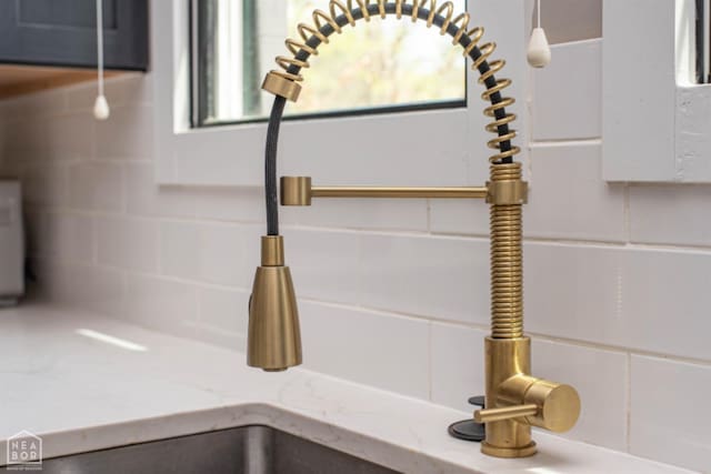 details featuring backsplash and light stone countertops