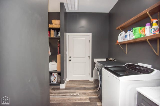 laundry area with washer and dryer, laundry area, wood finished floors, and visible vents