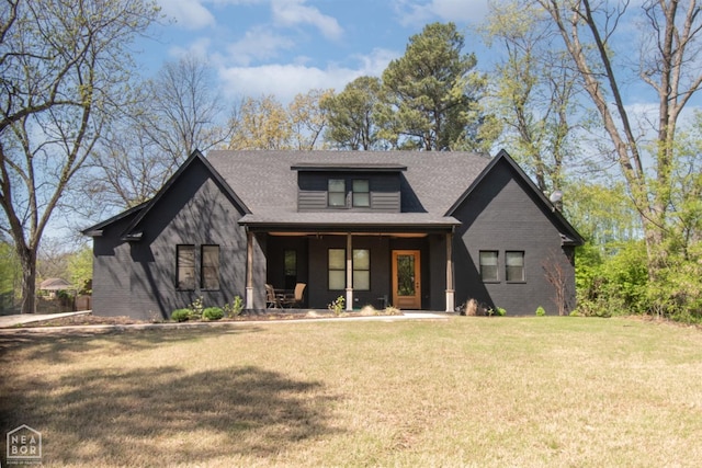 modern farmhouse featuring a front yard, a porch, and a shingled roof