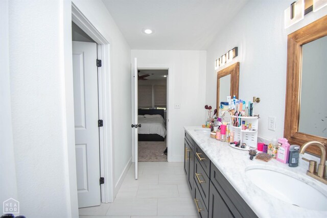 bathroom with ensuite bath, tile patterned flooring, recessed lighting, a sink, and double vanity