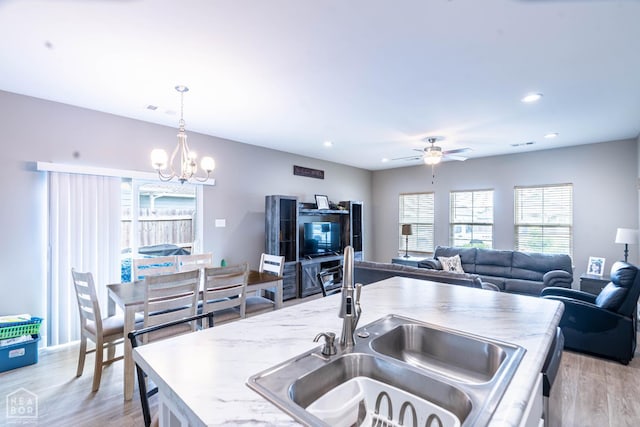 3620 Leafy Pass, Jonesboro, AR 72404 - kitchen with a sink, a ceiling fan, a chandelier, light wood finished floors, and recessed lighting