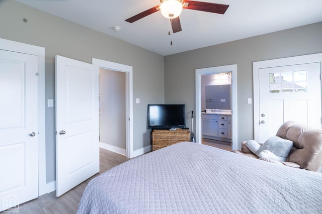 3620 Leafy Pass, Jonesboro, AR 72404 - bedroom featuring wood finished floors, baseboards, ensuite bathroom, and a ceiling fan