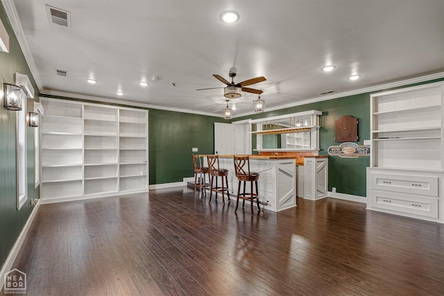 bar featuring dark wood-type flooring, crown molding, a ceiling fan, and visible vents