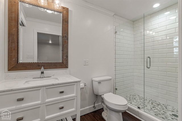 bathroom featuring toilet, wood finished floors, ornamental molding, and a shower stall
