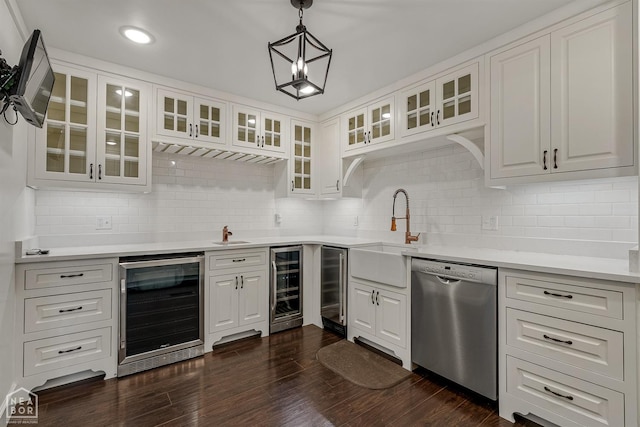 kitchen featuring a sink, stainless steel dishwasher, beverage cooler, and decorative backsplash