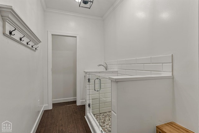 interior space featuring ornamental molding, baseboards, and dark wood finished floors
