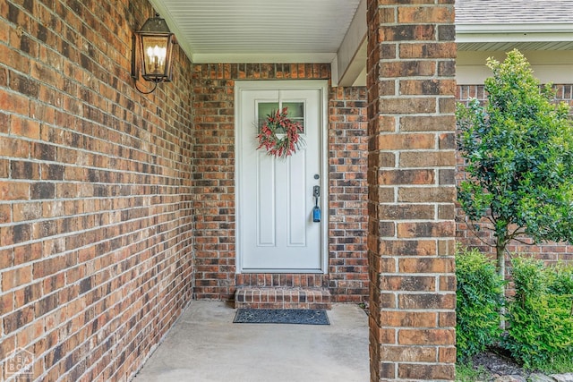 view of exterior entry with brick siding