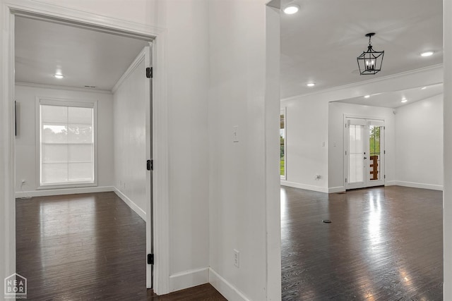entryway featuring ornamental molding, baseboards, and dark wood finished floors