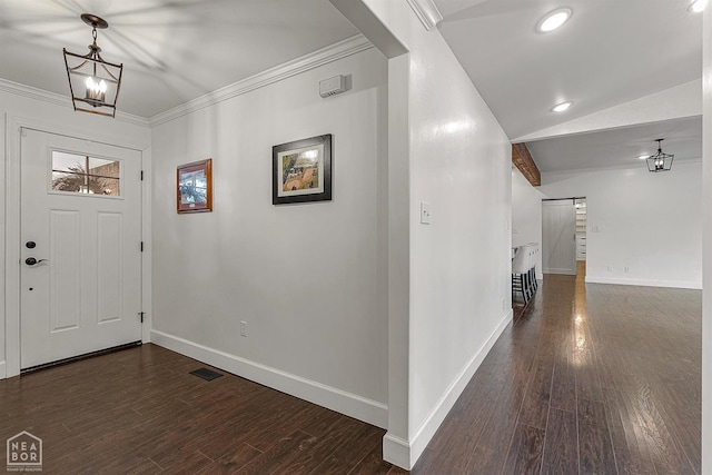 foyer featuring ornamental molding, baseboards, an inviting chandelier, and dark wood finished floors