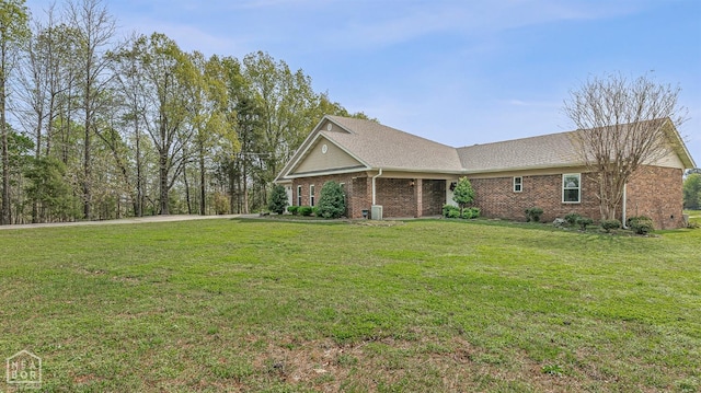 view of property exterior with brick siding and a lawn