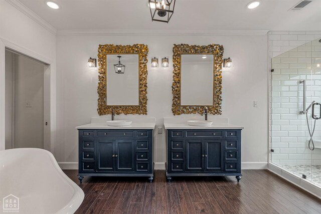 full bathroom featuring baseboards, a stall shower, visible vents, a sink, and wood finished floors
