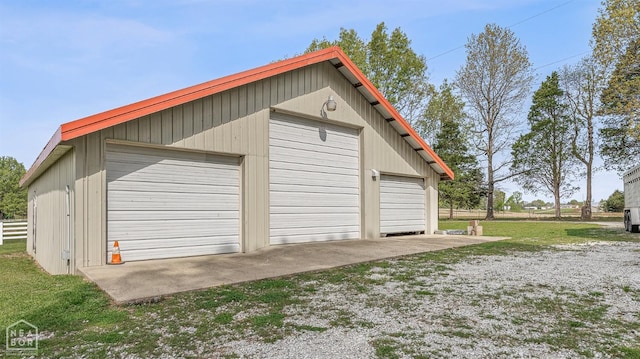 detached garage featuring fence