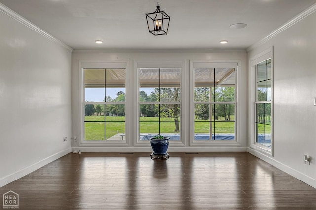 interior space featuring crown molding, a healthy amount of sunlight, dark wood-style flooring, and baseboards