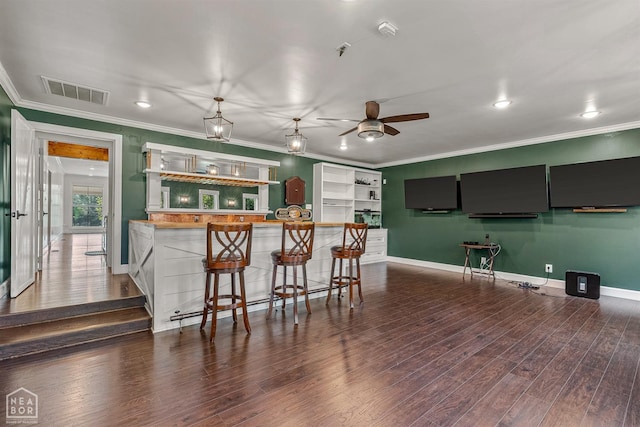 bar with visible vents, baseboards, ornamental molding, ceiling fan, and dark wood finished floors