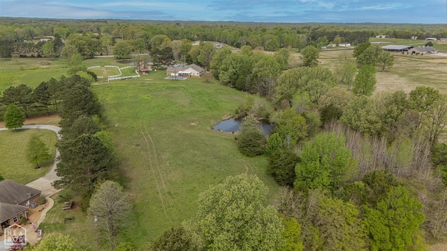drone / aerial view with a wooded view