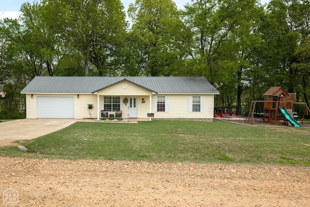 view of front of house featuring a garage, a porch, a front lawn, and metal roof