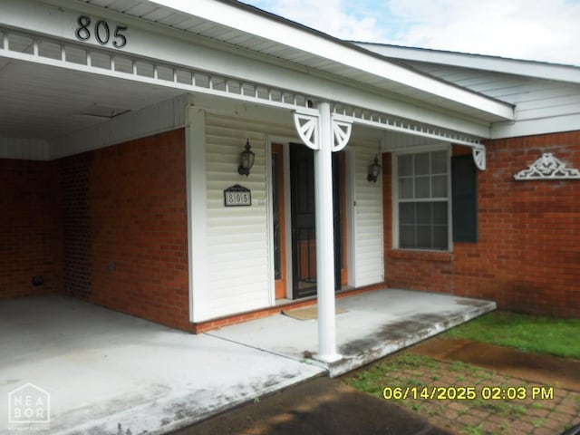805 Cherokee Dr, Newport, AR 72112 - view of exterior entry featuring brick siding and a porch