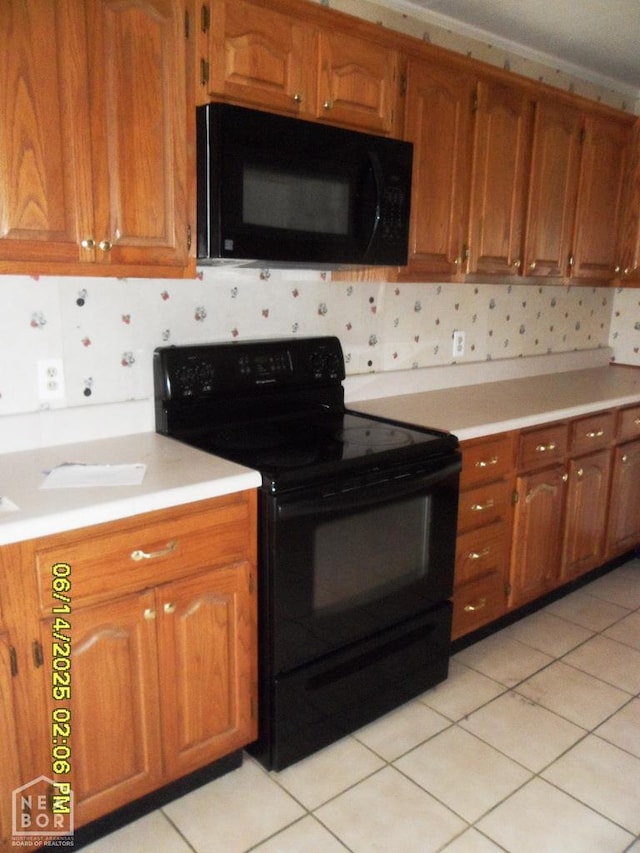 805 Cherokee Dr, Newport, AR 72112 - kitchen featuring black appliances, light countertops, brown cabinetry, decorative backsplash, and light tile patterned floors