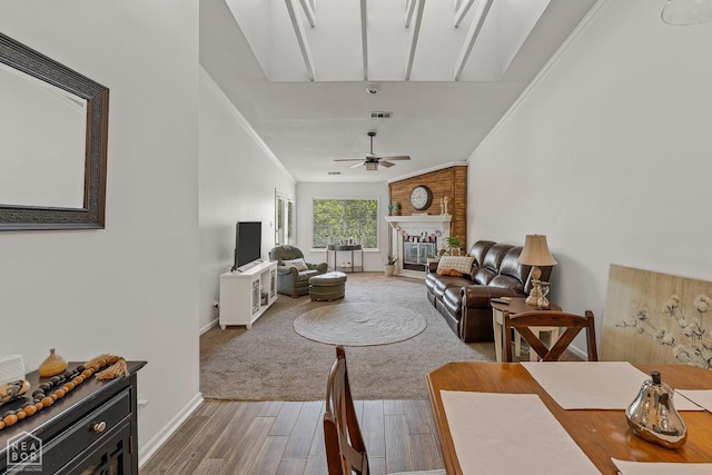 1300 S Church St S, Jonesboro, AR 72401 - living area with wood finished floors, baseboards, a ceiling fan, a brick fireplace, and ornamental molding