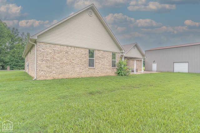 2 Deer Run, Clarksville, AR 72830 - view of home's exterior featuring brick siding, a yard, a patio, and an outdoor structure