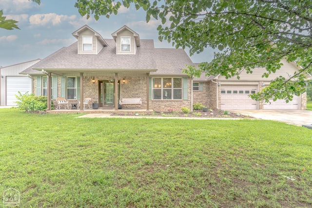 2 Deer Run, Clarksville, AR 72830 - cape cod house featuring a porch, concrete driveway, a front lawn, an attached garage, and brick siding