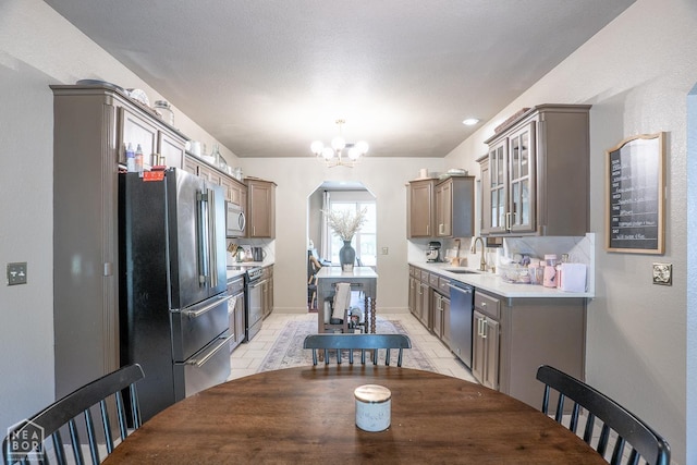 2 Deer Run, Clarksville, AR 72830 - kitchen with appliances with stainless steel finishes, a chandelier, glass insert cabinets, light countertops, and arched walkways