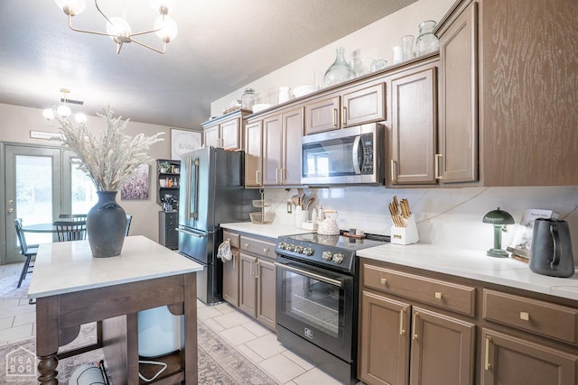 2 Deer Run, Clarksville, AR 72830 - kitchen featuring stainless steel appliances, a chandelier, backsplash, and light countertops