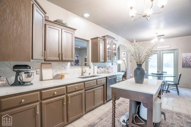 2 Deer Run, Clarksville, AR 72830 - kitchen featuring a chandelier, stainless steel dishwasher, light tile patterned floors, light countertops, and arched walkways