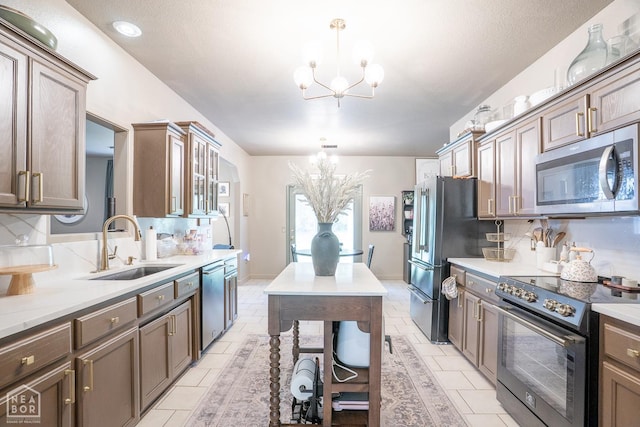2 Deer Run, Clarksville, AR 72830 - kitchen featuring stainless steel appliances, a chandelier, pendant lighting, and tasteful backsplash