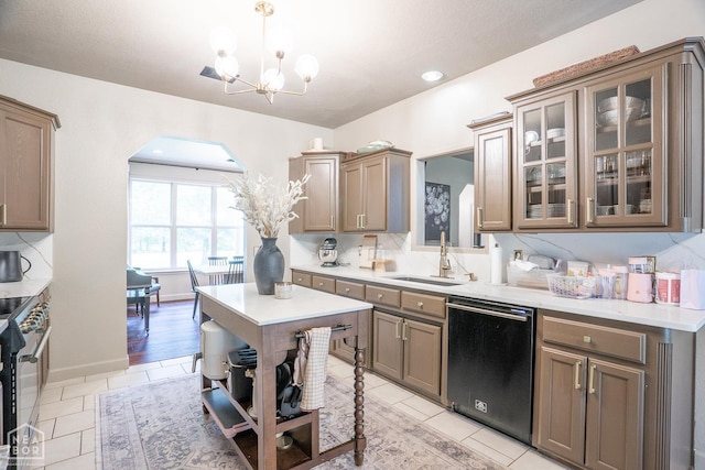 2 Deer Run, Clarksville, AR 72830 - kitchen with dishwasher, a chandelier, high end range, light countertops, and glass insert cabinets