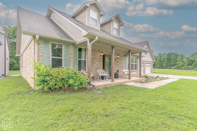 2 Deer Run, Clarksville, AR 72830 - view of front facade featuring covered porch, a front lawn, a garage, concrete driveway, and brick siding
