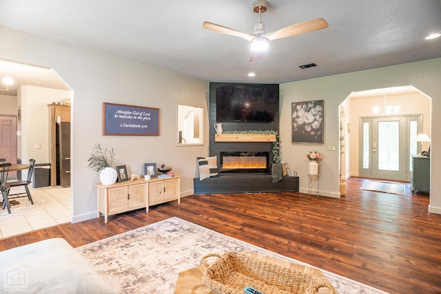 2 Deer Run, Clarksville, AR 72830 - living room with arched walkways, wood finished floors, ceiling fan, and a large fireplace