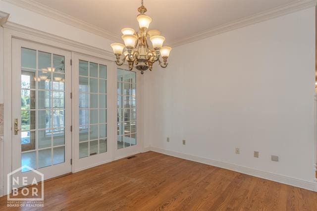 3201 S 2nd Ave S, Paragould, AR 72450 - unfurnished room with wood finished floors, a chandelier, and crown molding
