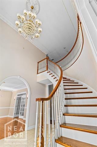 3201 S 2nd Ave S, Paragould, AR 72450 - staircase with arched walkways, a chandelier, and a towering ceiling