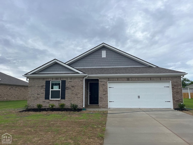 119 Terry Dr, Brookland, AR 72417 - view of front facade with concrete driveway, brick siding, roof with shingles, a front lawn, and a garage
