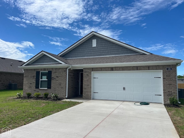 119 Terry Dr, Brookland, AR 72417 - ranch-style house with brick siding, concrete driveway, roof with shingles, a front yard, and an attached garage