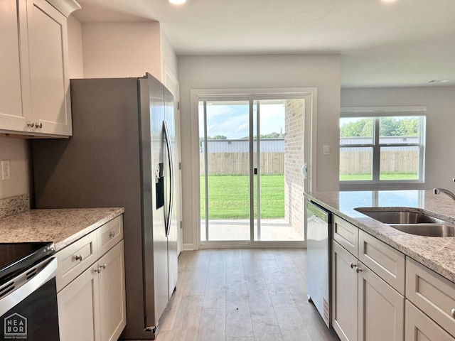 119 Terry Dr, Brookland, AR 72417 - kitchen with appliances with stainless steel finishes, light wood-style floors, light stone countertops, and recessed lighting