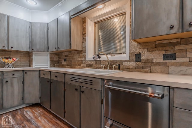 kitchen with a sink, stainless steel dishwasher, light countertops, tasteful backsplash, and ornamental molding