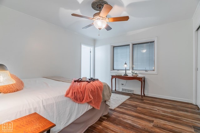 bedroom featuring visible vents, wood finished floors, baseboards, and ceiling fan